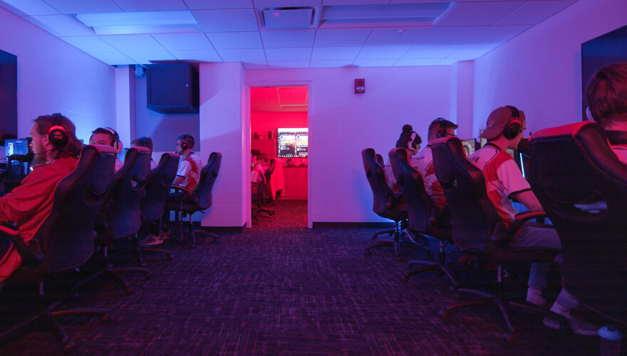 esports team members on computers in room with gaming computers