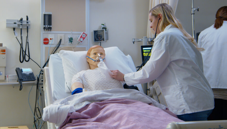 nursing student in nursing simulation lab working on test patient