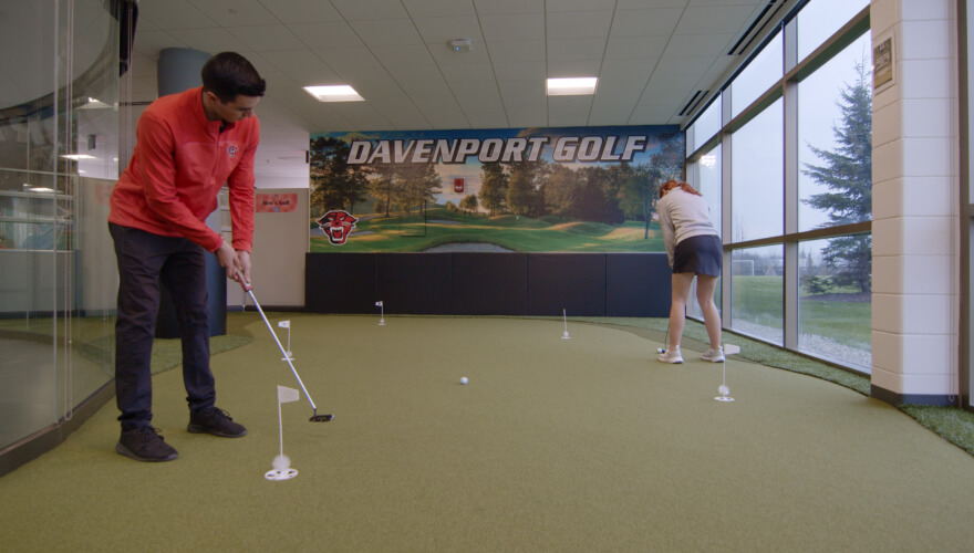 man and woman on turf golf green