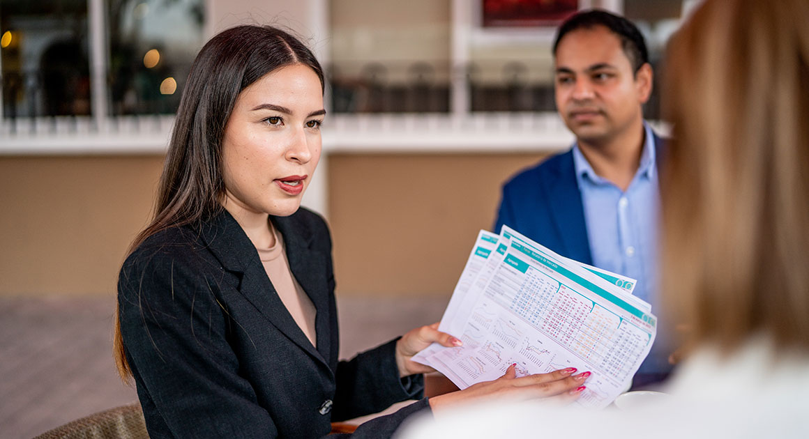 Two professionals. One women holding documents 