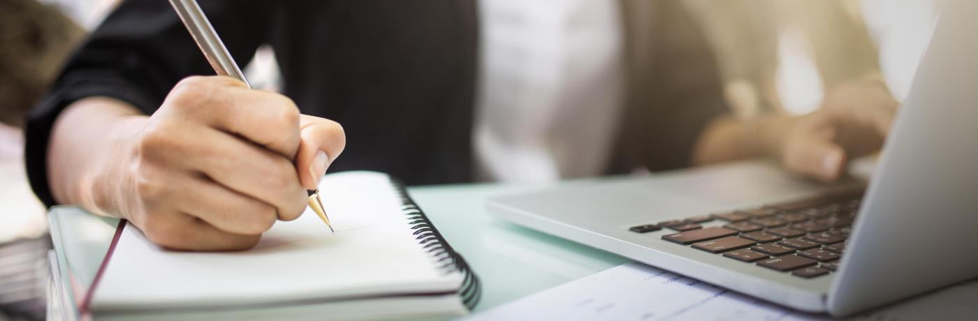 Woman on computer with notebook