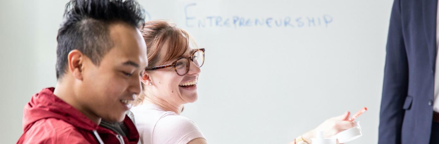 two students in classroom laughing