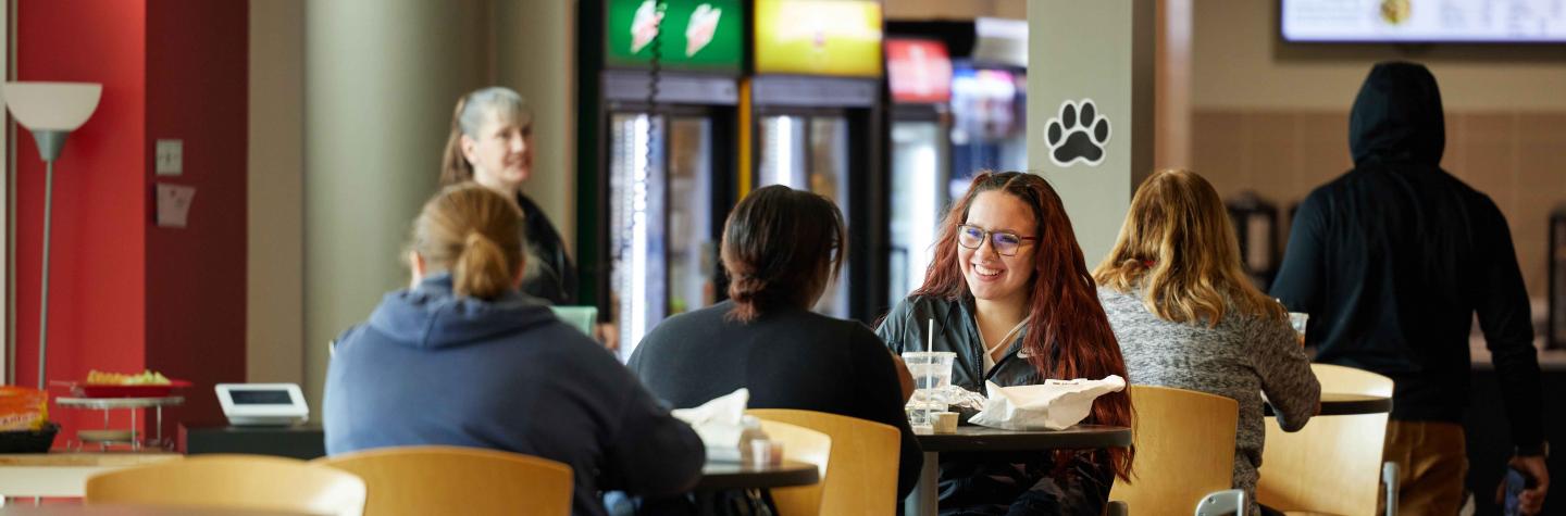 Students eating at The Den dining place on the W.A. Lettinga campus