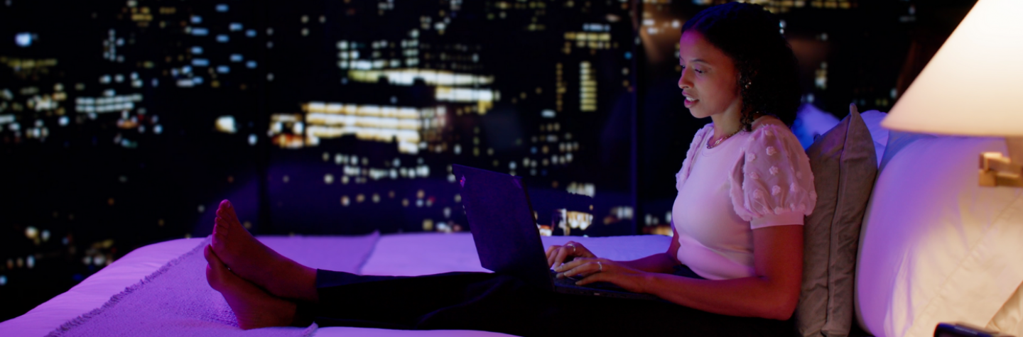 Female in a city hotel room on her laptop