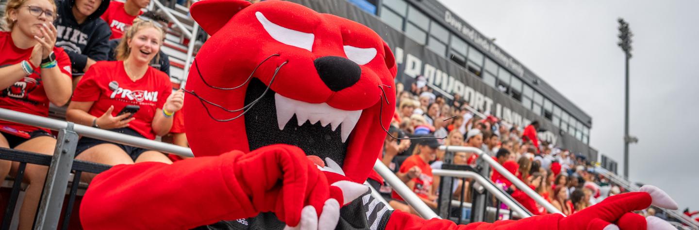 Pounce in front of the student section at a Davenport football game