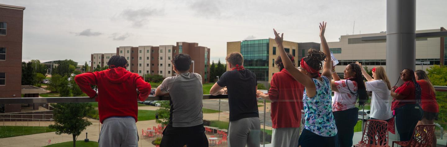Students on the College of Business balcony