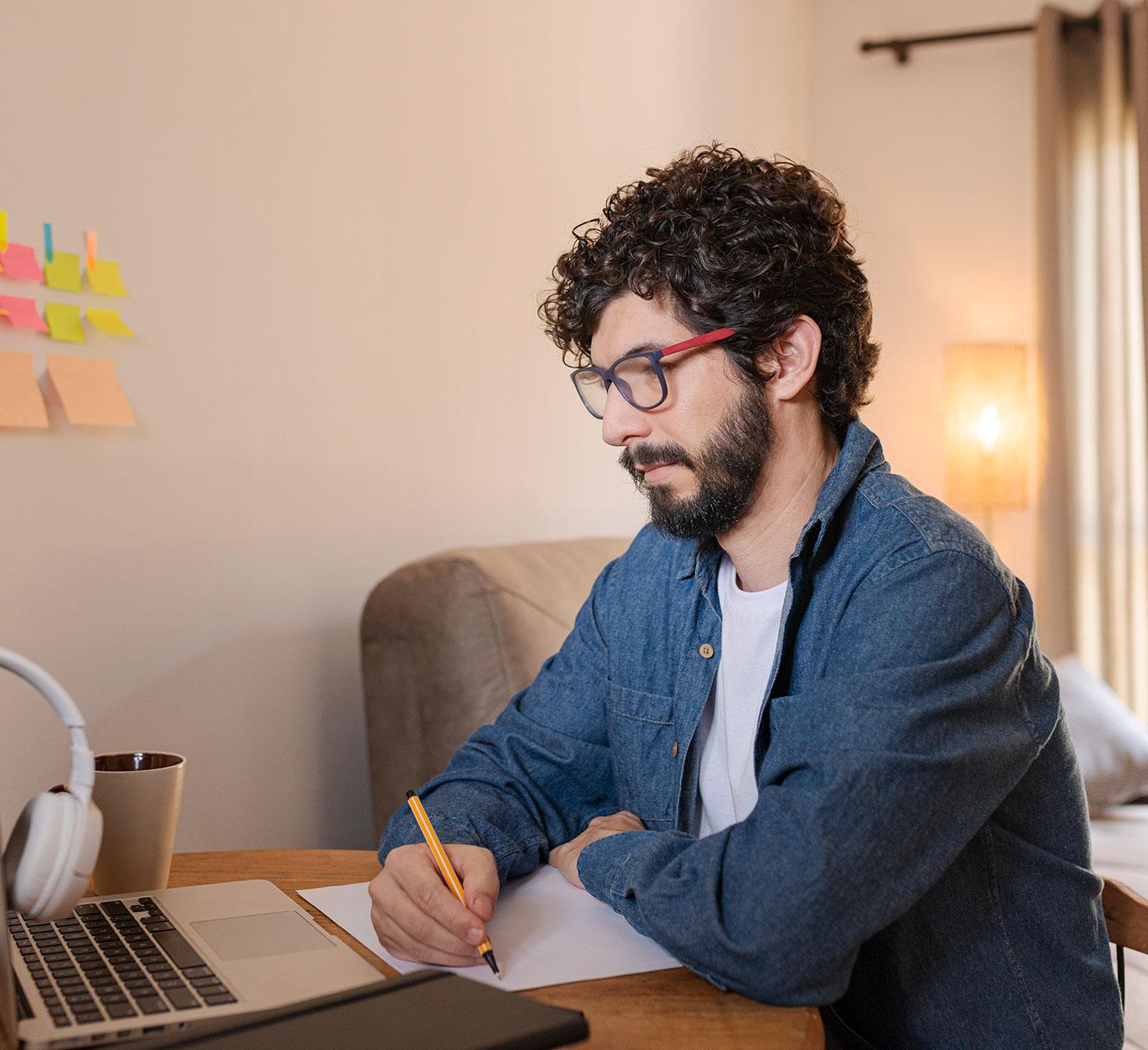 Young man studying at his laptop