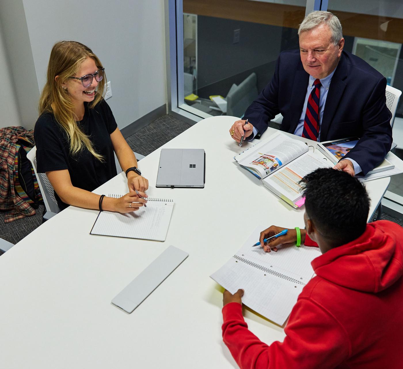 Small group tutoring session with a professor and two students