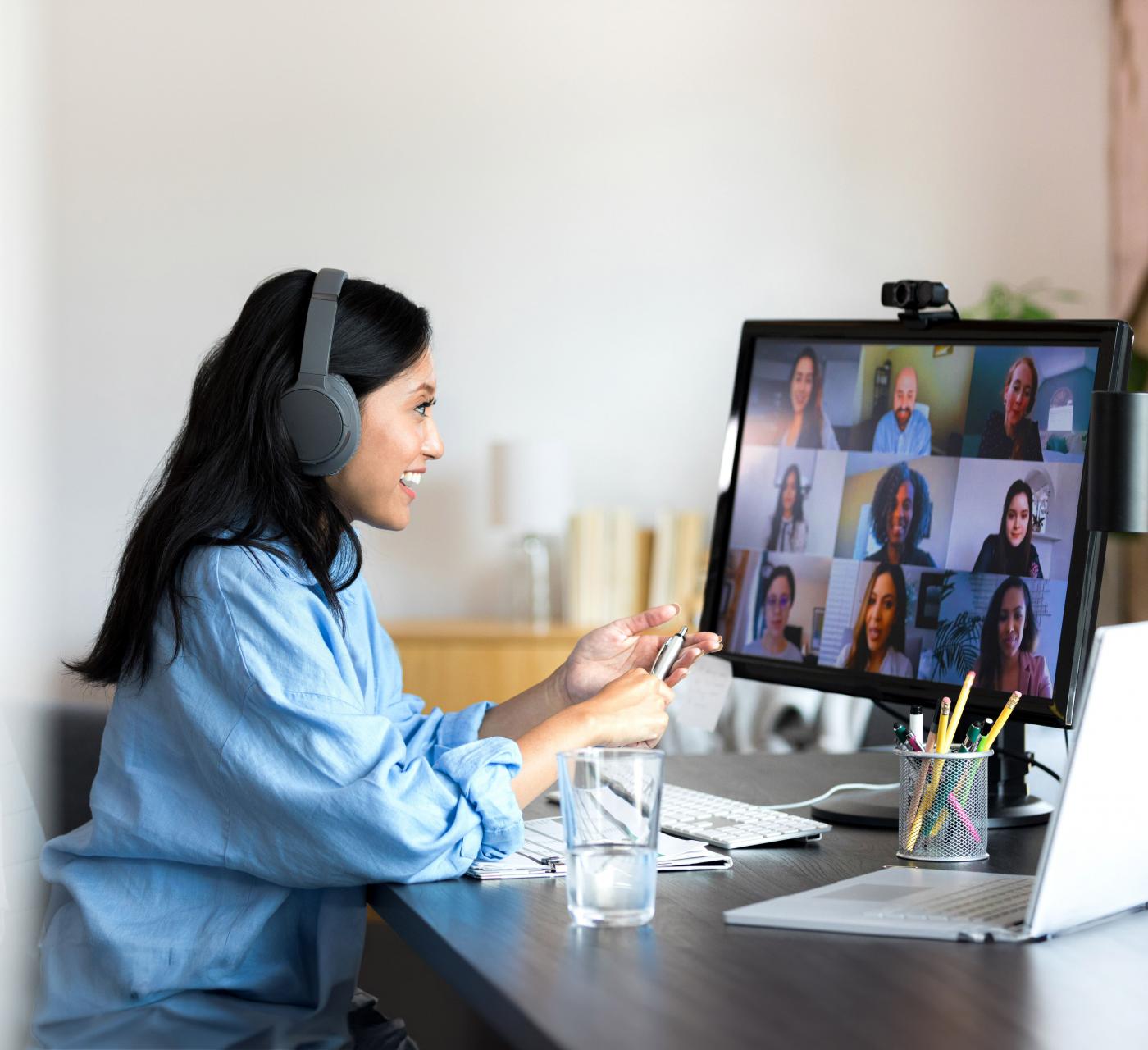 Young female at a desk on a virtual meeting on her computer