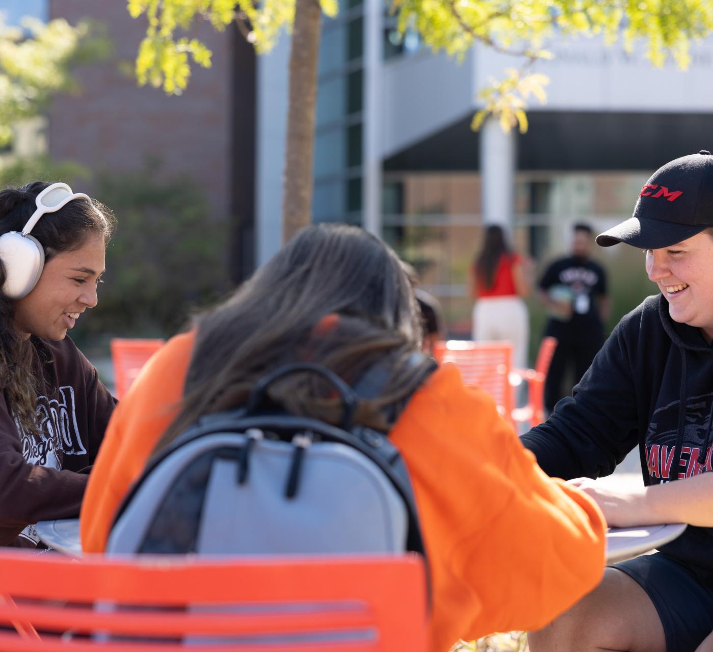 Students outside studying at a table
