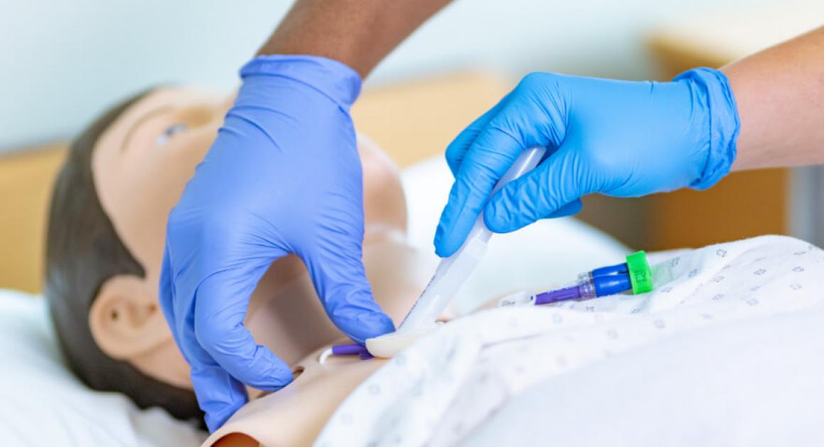 Two nursing students with hands on simulation patient