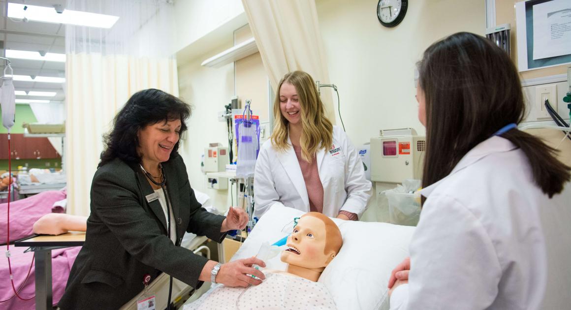 Nursing Professor with Two Nursing Students in Simulation Lab