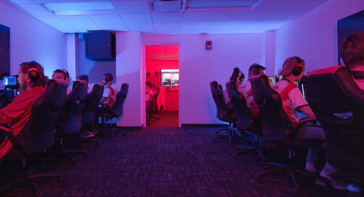 esports team members on computers in room with gaming computers