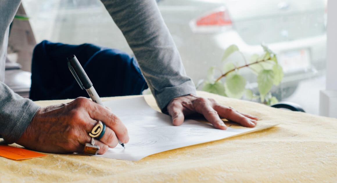 Hands resting on a desk, completing legal paperwork