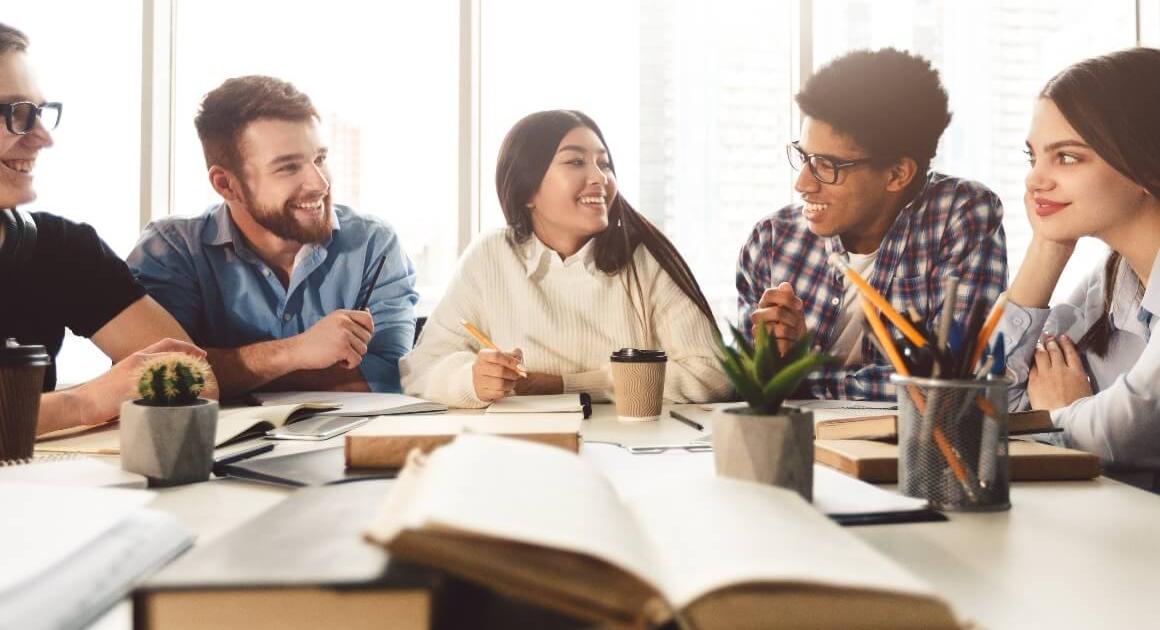 Students sitting around a table, talking