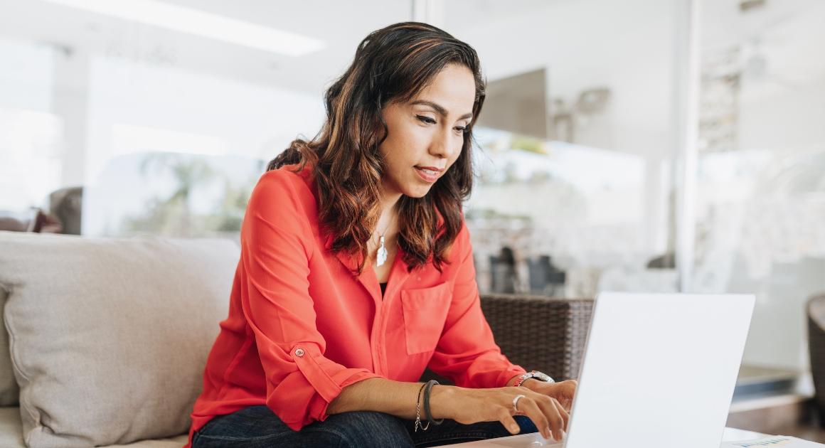 Young woman typing on a laptop.