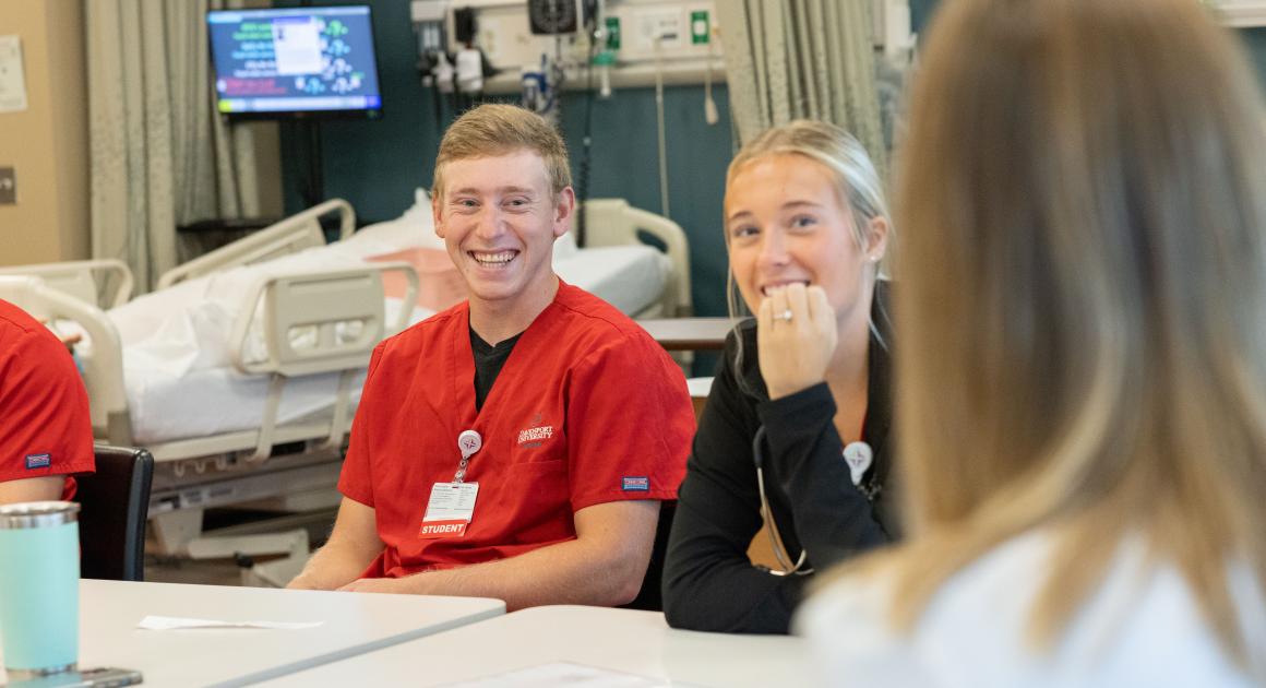 A male and a female nursing student in class