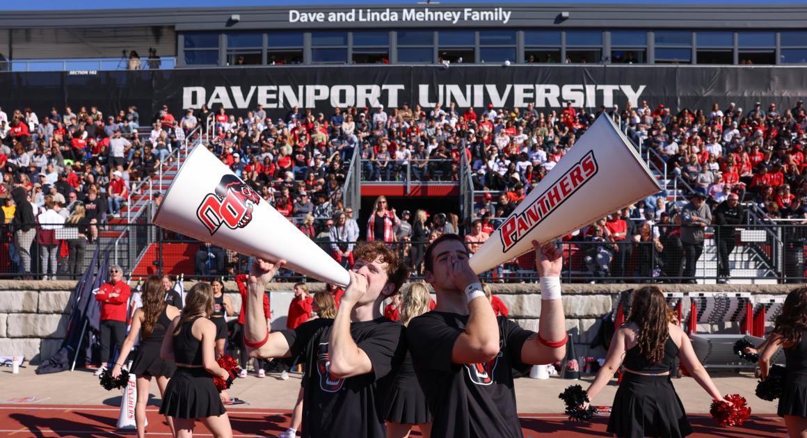 A picture of the fans in the stands and cheerleaders at the 2024 Homecoming game