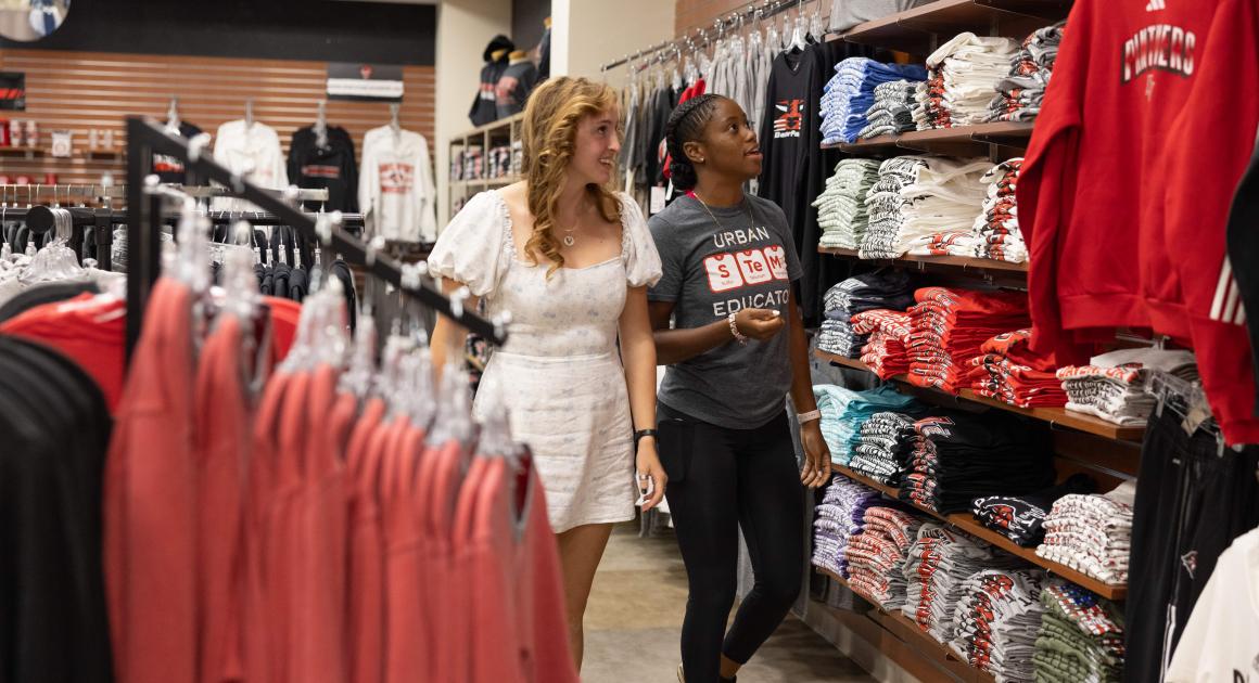 Two female students shopping at Davenport's Spirit Store