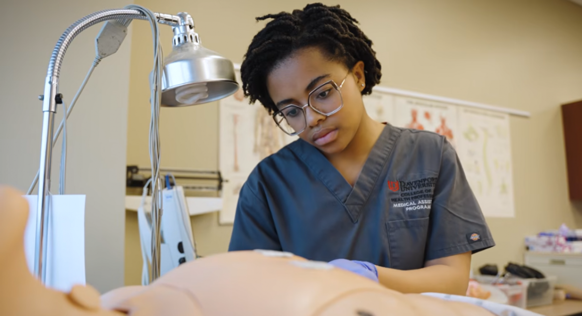 Female student in the medal assisting program in the nursing lab